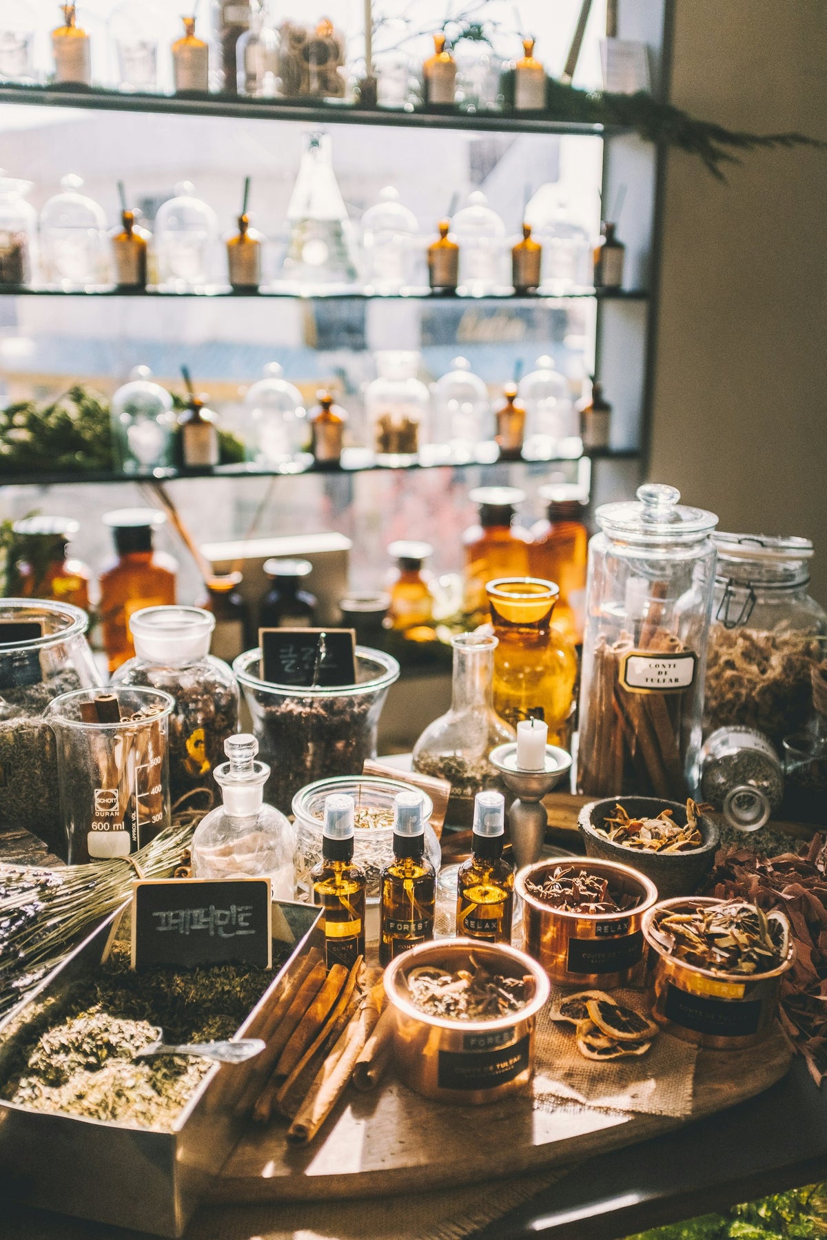 Glass jars of dried herbs and spices on a table